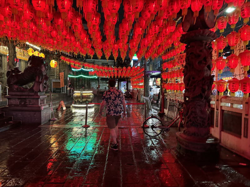 Walking in front of a temple in Taipei on a rainy night