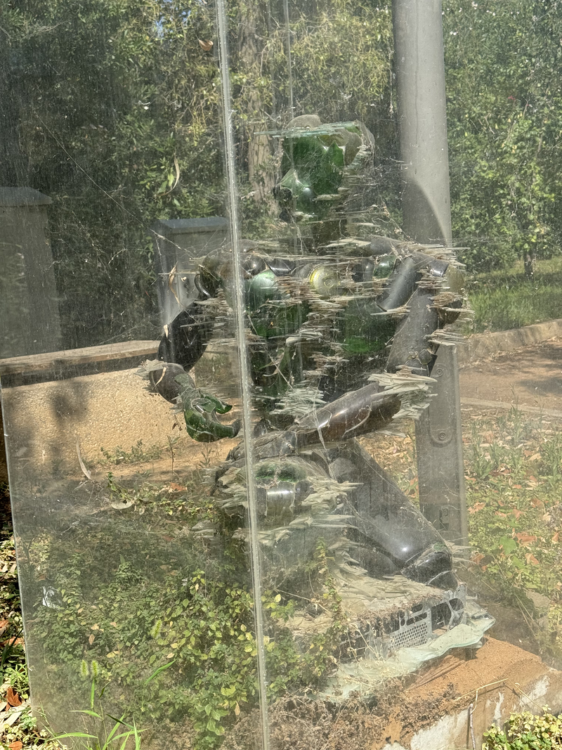 A glass sculpture of a man thinking despite the unrelenting attack of techology