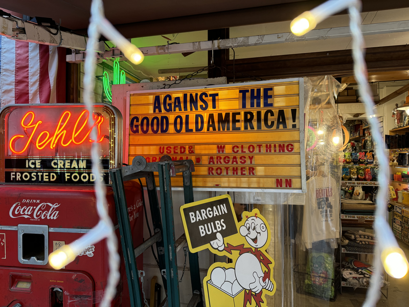 Thrift shop sign saying “Against the Good Old America”