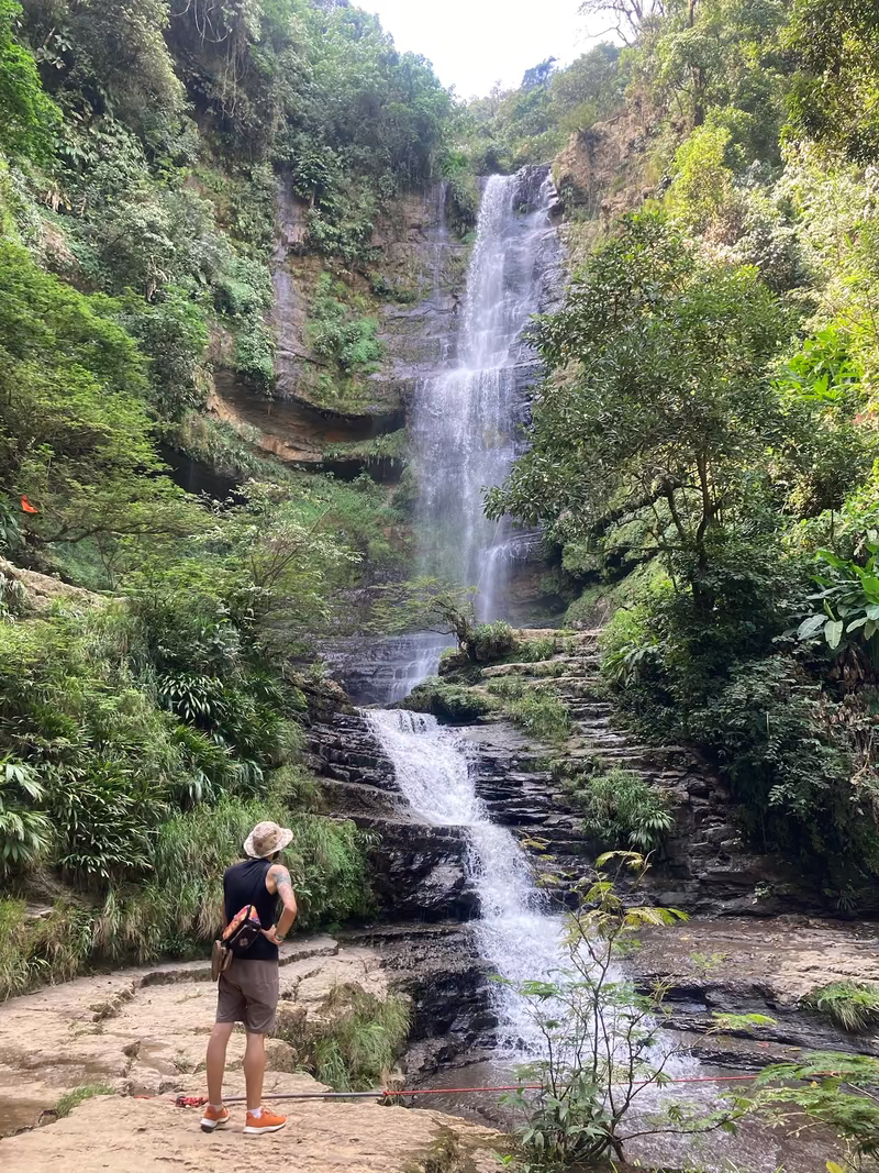 Standing before the Juan Curi waterfall